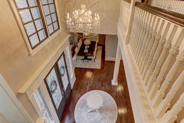 9470 Riveredge Dr, Memphis, TN 38018 - foyer with dark wood-style flooring, a chandelier, a high ceiling, stairway, and baseboards
