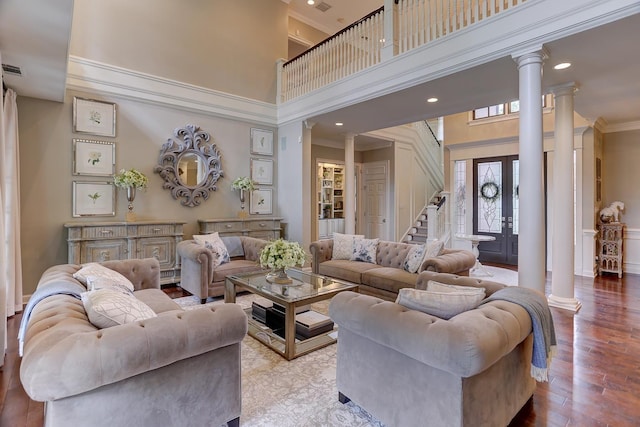 9470 Riveredge Dr, Memphis, TN 38018 - living area with ornate columns, a high ceiling, crown molding, wood finished floors, and stairway