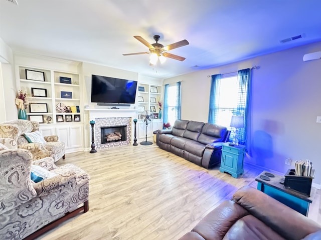 10156 Amberton Cv, Cordova, TN 38018 - living room featuring a ceiling fan, wood finished floors, a fireplace, and built in shelves