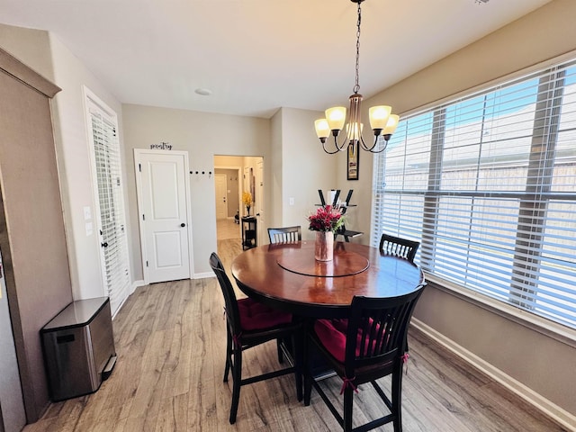 10156 Amberton Cv, Cordova, TN 38018 - dining area featuring light wood-type flooring, baseboards, and a chandelier