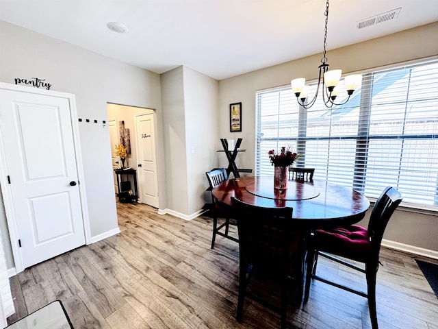 10156 Amberton Cv, Cordova, TN 38018 - dining area with a chandelier, plenty of natural light, light wood-style flooring, and baseboards