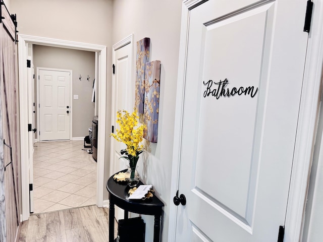 10156 Amberton Cv, Cordova, TN 38018 - corridor featuring light tile patterned floors and a barn door