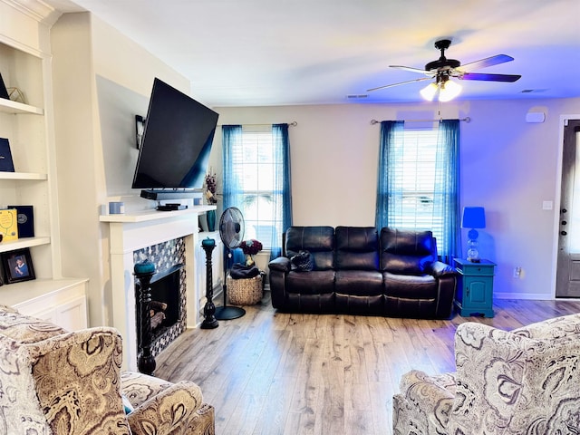 10156 Amberton Cv, Cordova, TN 38018 - living room with a ceiling fan, hardwood / wood-style flooring, built in features, and a tile fireplace