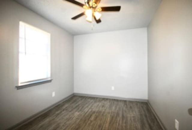487 Williams Ave, Memphis, TN 38126 - empty room featuring baseboards, ceiling fan, and dark wood-style flooring