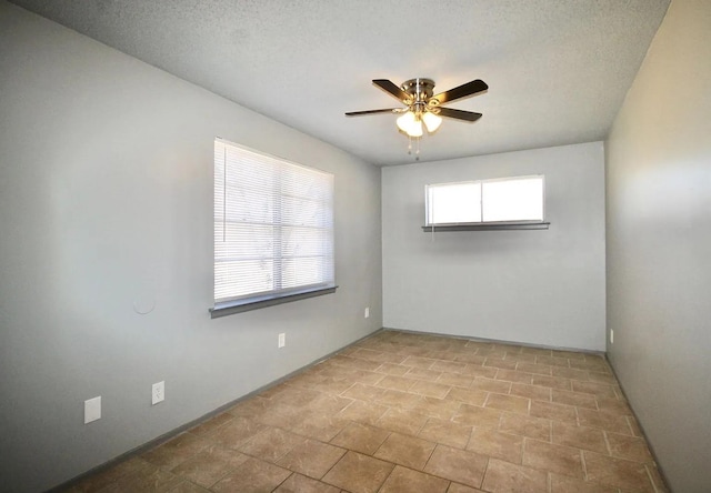 487 Williams Ave, Memphis, TN 38126 - empty room with a ceiling fan, a textured ceiling, and baseboards