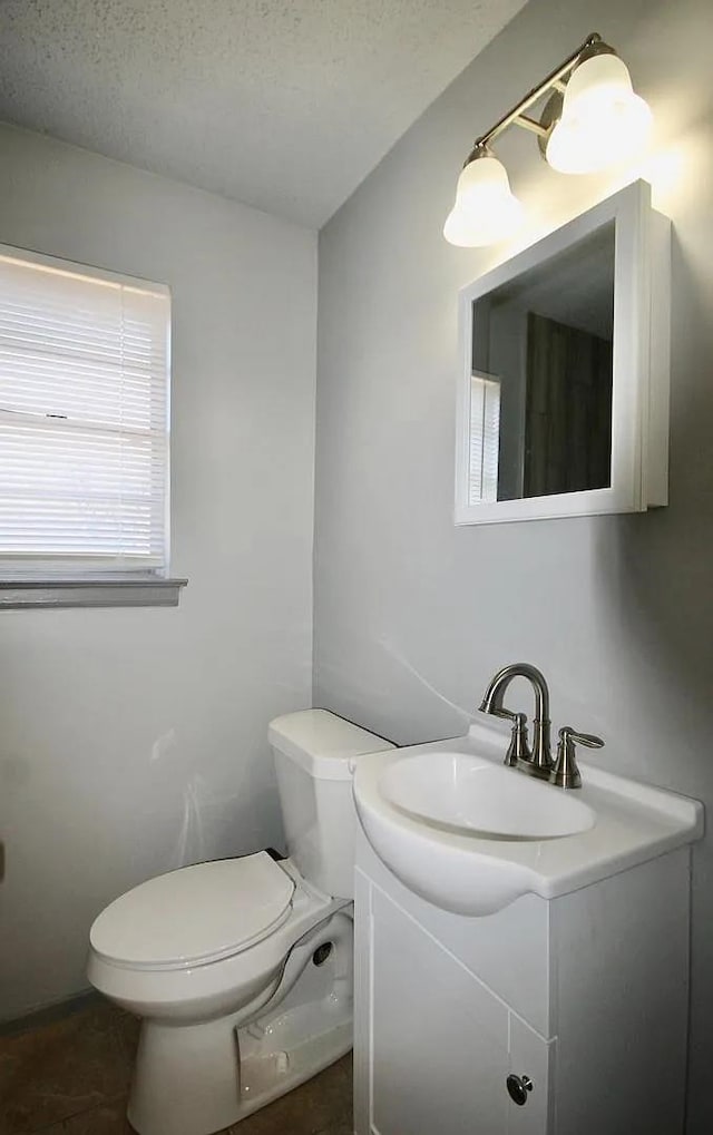 487 Williams Ave, Memphis, TN 38126 - bathroom featuring vanity, toilet, a textured ceiling, and tile patterned flooring
