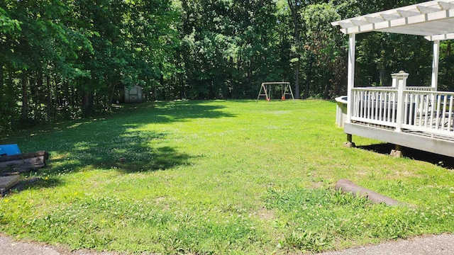 445 Caldwell Rd, Ripley, TN 38063 - view of grassy yard featuring a wooden deck and a pergola