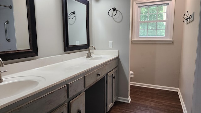 445 Caldwell Rd, Ripley, TN 38063 - bathroom with toilet, wood finished floors, double vanity, and baseboards