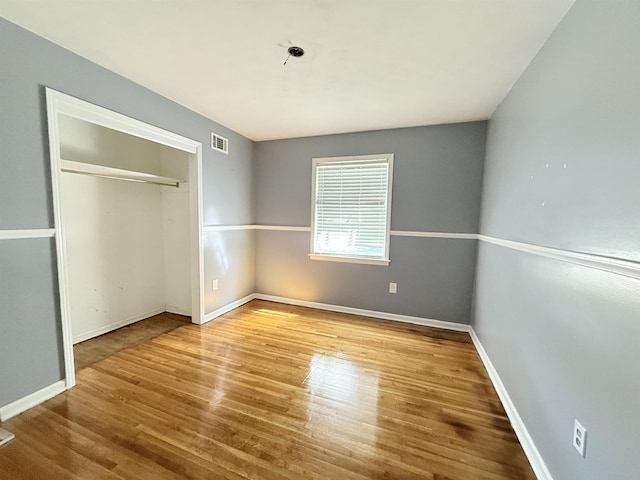 1170 Stage Ave, Memphis, TN 38127 - unfurnished bedroom with wood finished floors, a closet, and baseboards