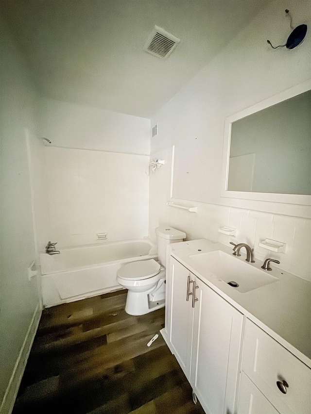 1170 Stage Ave, Memphis, TN 38127 - bathroom with toilet, vanity, wood finished floors, and bathtub / shower combination