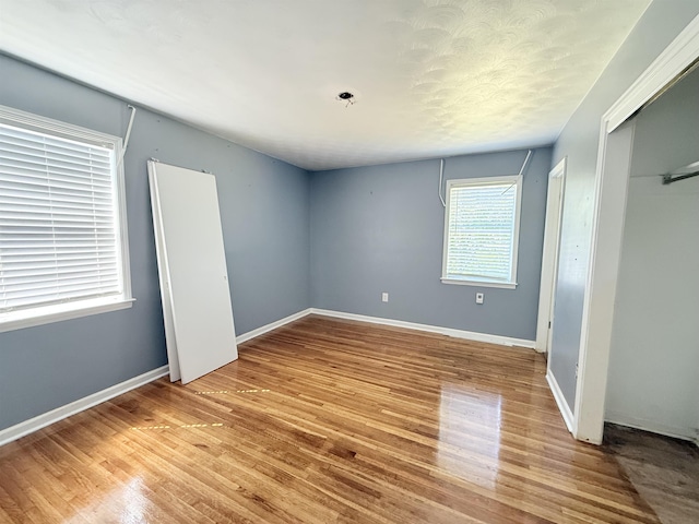 1170 Stage Ave, Memphis, TN 38127 - unfurnished bedroom with wood finished floors, a closet, and baseboards