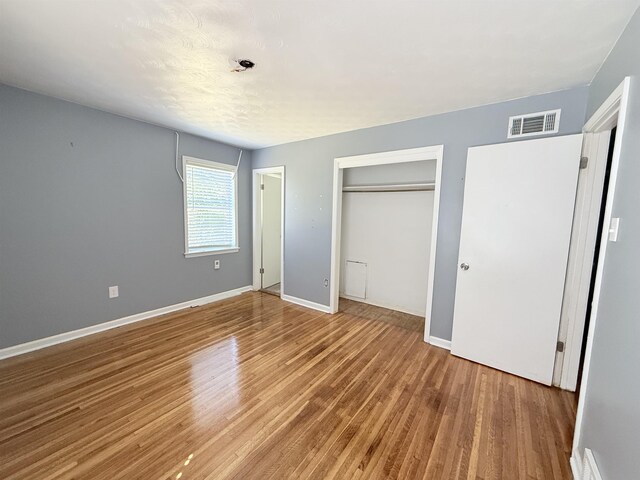 1170 Stage Ave, Memphis, TN 38127 - unfurnished bedroom featuring wood finished floors, a closet, and baseboards