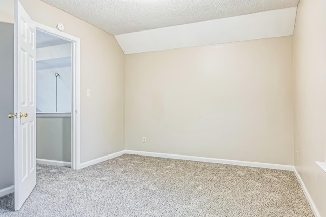 1168 E Red Fern Cir, Cordova, TN 38018 - carpeted empty room featuring lofted ceiling, a textured ceiling, and baseboards
