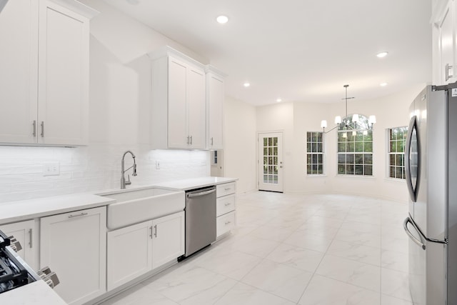 95 Hancock Cv, Eads, TN 38028 - kitchen with appliances with stainless steel finishes, a sink, light marble finish floors, light countertops, and recessed lighting