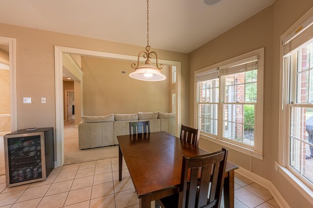 10223 Poston Oaks Cir, Collierville, TN 38017 - dining area with wine cooler, light tile patterned flooring, plenty of natural light, and vaulted ceiling