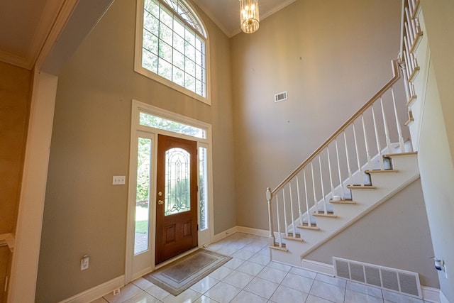 10223 Poston Oaks Cir, Collierville, TN 38017 - entrance foyer with light tile patterned flooring, a towering ceiling, crown molding, stairs, and baseboards