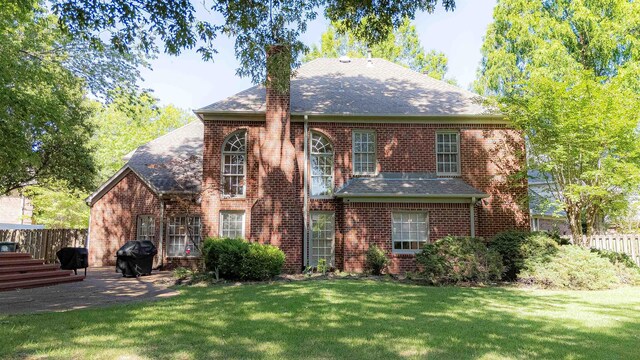 10223 Poston Oaks Cir, Collierville, TN 38017 - back of property with a chimney, brick siding, and roof with shingles