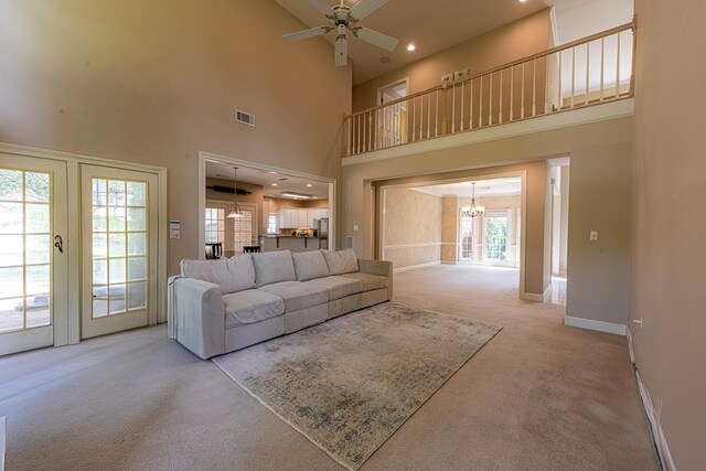 10223 Poston Oaks Cir, Collierville, TN 38017 - living area featuring carpet flooring, a high ceiling, baseboards, a ceiling fan, and a chandelier