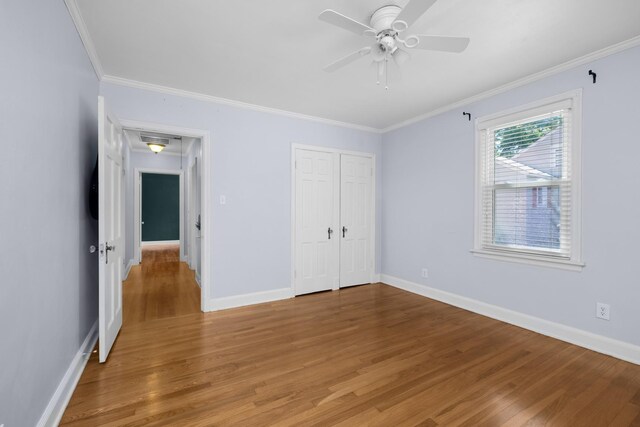 18 N Reese St, Memphis, TN 38111 - unfurnished bedroom with light wood-style floors, crown molding, baseboards, a closet, and ceiling fan