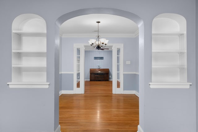 18 N Reese St, Memphis, TN 38111 - corridor featuring built in shelves, a chandelier, wood finished floors, crown molding, and baseboards