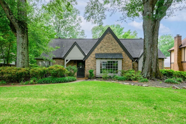 2349 Riverdale Rd, Germantown, TN 38138 - english style home featuring a front lawn, a shingled roof, and brick siding