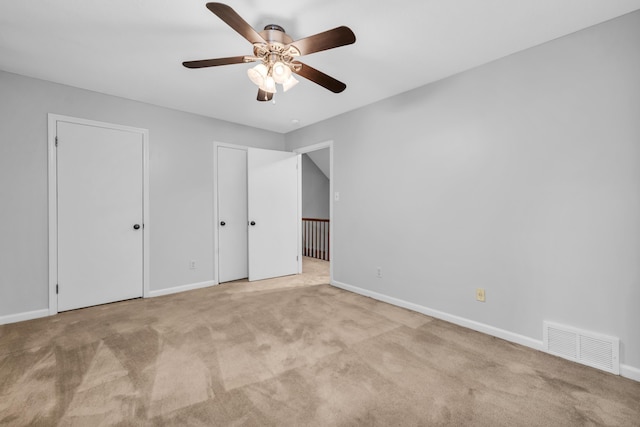 2349 Riverdale Rd, Germantown, TN 38138 - unfurnished bedroom featuring multiple closets, carpet floors, baseboards, and a ceiling fan