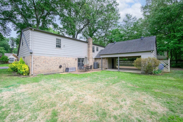 2349 Riverdale Rd, Germantown, TN 38138 - back of house with a lawn, a patio area, central AC, brick siding, and a chimney