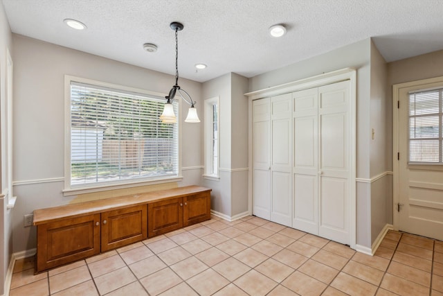 7617 Hollow Fork Rd, Germantown, TN 38138 - unfurnished dining area with light tile patterned floors, baseboards, a textured ceiling, and recessed lighting