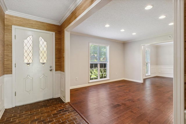 7617 Hollow Fork Rd, Germantown, TN 38138 - entryway with a textured ceiling, crown molding, a wainscoted wall, and dark wood-style floors