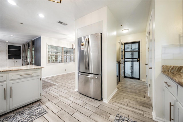 5796 N Foxburrow Cir, Memphis, TN 38115 - kitchen with freestanding refrigerator, baseboards, white cabinets, light wood-style flooring, and recessed lighting