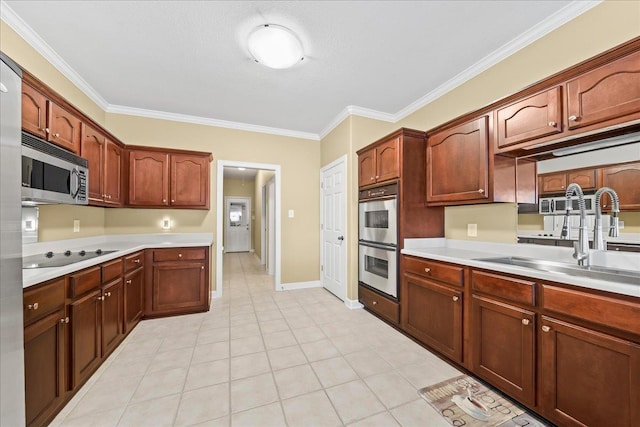 1166 Sanbyrn Dr, Cordova, TN 38018 - kitchen with stainless steel appliances, a sink, light countertops, crown molding, and light tile patterned floors