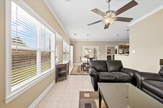 1166 Sanbyrn Dr, Cordova, TN 38018 - living area featuring baseboards, a ceiling fan, crown molding, light tile patterned floors, and a chandelier