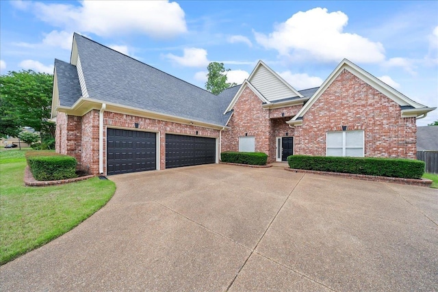 1166 Sanbyrn Dr, Cordova, TN 38018 - view of front of house with brick siding, driveway, a shingled roof, and a garage