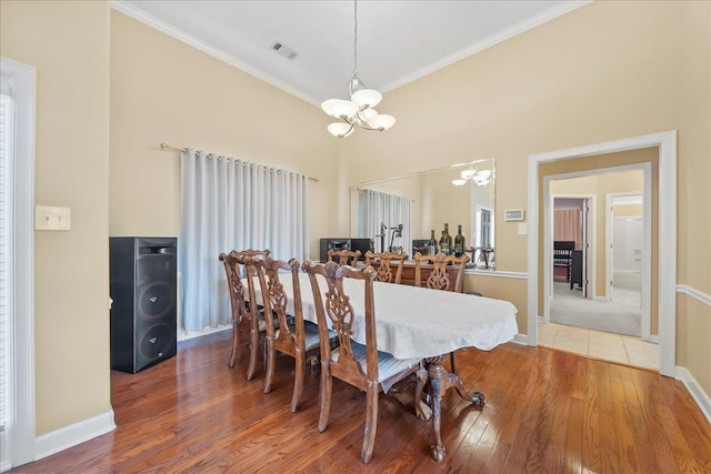 1166 Sanbyrn Dr, Cordova, TN 38018 - dining area with a chandelier, wood finished floors, ornamental molding, baseboards, and a towering ceiling