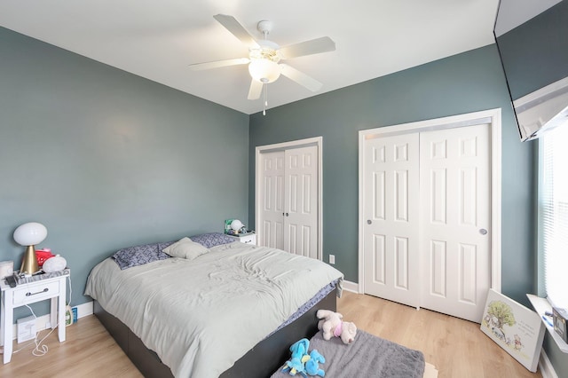 631 Peyton Cir, Memphis, TN 38107 - bedroom with two closets, light wood-style flooring, baseboards, and a ceiling fan