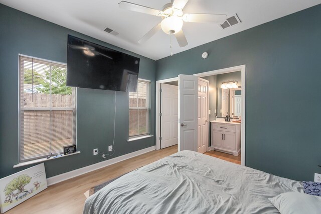 631 Peyton Cir, Memphis, TN 38107 - bedroom with light wood finished floors, ceiling fan, baseboards, and connected bathroom