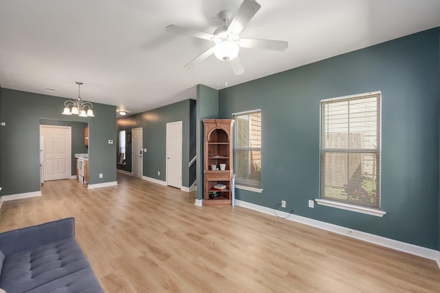 631 Peyton Cir, Memphis, TN 38107 - unfurnished living room with a chandelier, light wood-style flooring, ceiling fan, and baseboards