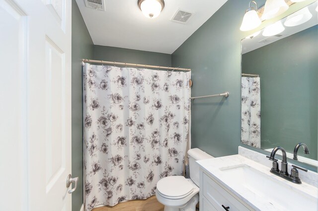 631 Peyton Cir, Memphis, TN 38107 - full bath featuring vanity, toilet, a shower with curtain, and wood finished floors