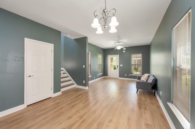 631 Peyton Cir, Memphis, TN 38107 - living area with a chandelier, light wood-type flooring, baseboards, stairs, and a ceiling fan