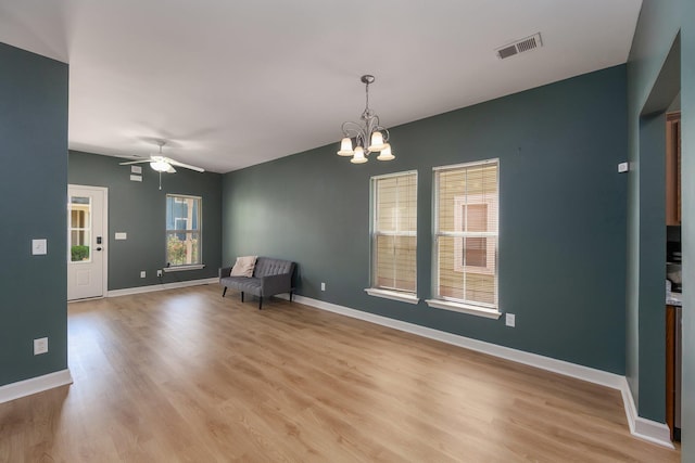 631 Peyton Cir, Memphis, TN 38107 - unfurnished room with a chandelier, a ceiling fan, light wood-style floors, and baseboards