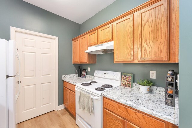 631 Peyton Cir, Memphis, TN 38107 - kitchen with white appliances, under cabinet range hood, light wood-style floors, baseboards, and light stone counters