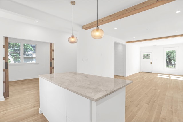 1995 Walker Ave, Memphis, TN 38104 - kitchen featuring healthy amount of natural light, beamed ceiling, light wood-style floors, a kitchen island, and recessed lighting