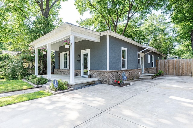 2046 Courtland Pl, Memphis, TN 38104 - view of front of house with a porch, stone siding, and stucco siding