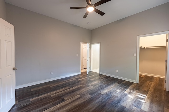 2046 Courtland Pl, Memphis, TN 38104 - unfurnished bedroom featuring dark wood finished floors, baseboards, a walk in closet, ceiling fan, and a closet