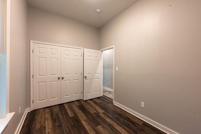 2046 Courtland Pl, Memphis, TN 38104 - unfurnished bedroom with dark wood-type flooring, baseboards, and a closet