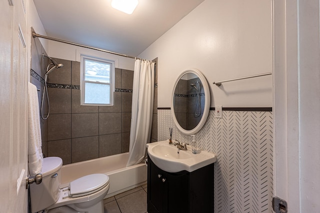 2046 Courtland Pl, Memphis, TN 38104 - full bathroom with tile patterned floors, vanity, toilet, shower / tub combo with curtain, and a wainscoted wall