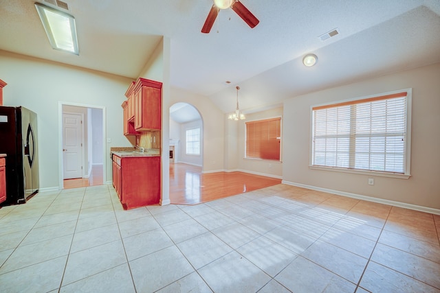 130 Pinehurst Dr, Oakland, TN 38060 - kitchen featuring black fridge with ice dispenser, light tile patterned floors, arched walkways, lofted ceiling, and a ceiling fan