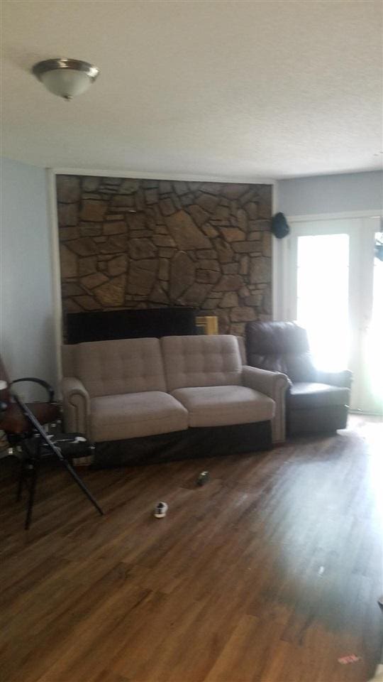 5647 Maple Tree Dr, Memphis, TN 38115 - living area featuring wood finished floors and a fireplace