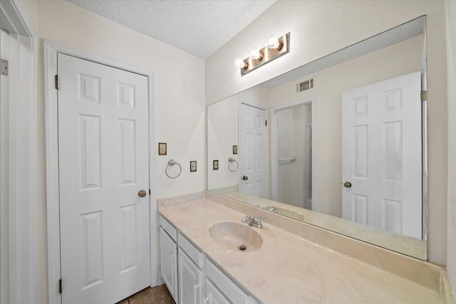 8174 Ravenhill Dr Unit 54, Germantown, TN 38138 - bathroom with vanity and a textured ceiling