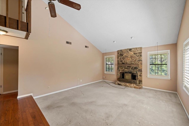 8174 Ravenhill Dr Unit 54, Germantown, TN 38138 - unfurnished living room featuring ceiling fan, high vaulted ceiling, baseboards, a stone fireplace, and carpet flooring
